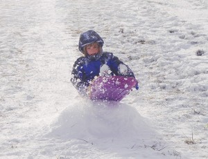 Winter fun! Alyssa's son Zane sledding over a jump. Photo by Bear.