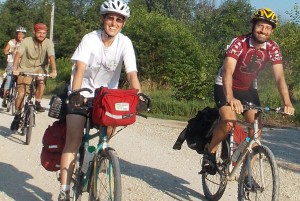 Rachel (front left) took off Wednesday for a 500 mile fundraising bike ride. In true Dancing Rabbit spirit, a group of villagers rode with her to see her off, including her partner Tony (front right). Photo by Dennis.
