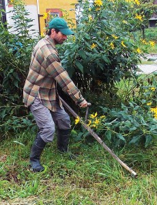 Alex brought out the scythe to trim grass for "Land Clean Day" at Dancing Rabbit. Photo by Dennis.