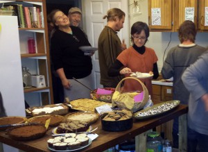 Thanksgiving at Dancing Rabbit: Tereza starts in the dessert section, while Alline smiles in the doorway. Photo by Illy.