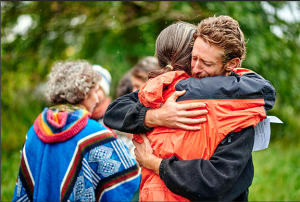 Two members of Men's Group support each other at Tamar's graveside service.