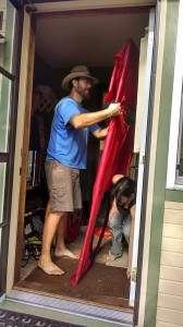 Bear and Jennifer wrestle the blower door into place. Photo by Tereza.