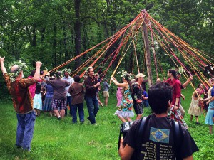Sandhillians, Rabbits, Red Earthers, and friends dance around the May Pole at Sandhill's May Day party. Photo by Nik.