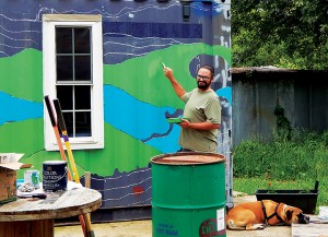 The shipping-container grocery store gets the first coat of its new mural. Photo by Alline.