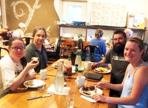 Feeding the "Brain Trust". Visiting researchers Josh, Ian and Bridget eating breakfast with Ma'ikwe. Photo by Katherine.