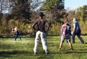 Dancing Rabbit celebrated its 18th anniversary Saturday with a family-oriented wiffle ball game. Here, young Emory gets ready to swing while Brent pitches. The score? Who cares? Photo by Dennis.