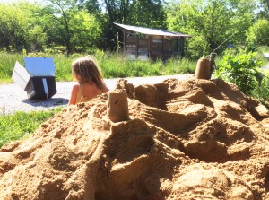 Katherine slows down and takes a break from preparing lunch to build sandcastles with Althea. Photo by Katherine.