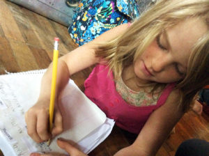 Althea works on a poem in homeschool. Photo by Christina.