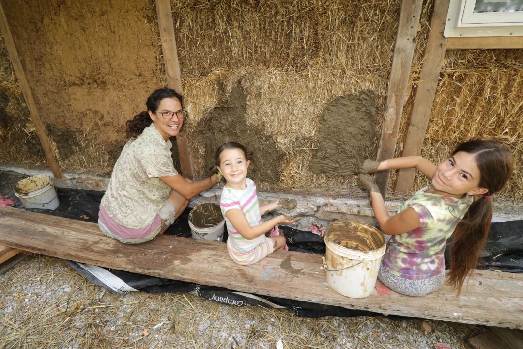 Rae sharing her knowledge of plaster with young ones